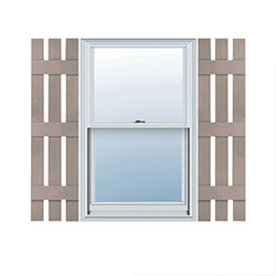 Stylish vinyl shutters add charm to a window, featuring a spaced board-and-batten design. Enhance curb appeal with these durable, low-maintenance options for a timeless look.