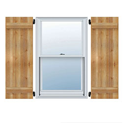 Charming rustic wood shutters frame a classic window, adding warmth and character to any home, enhancing curb appeal with natural texture and timeless design.